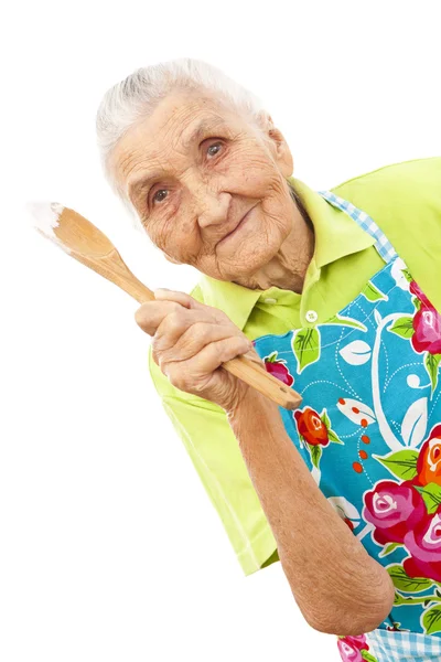 Felice vecchia donna con cucchiaio di legno — Foto Stock