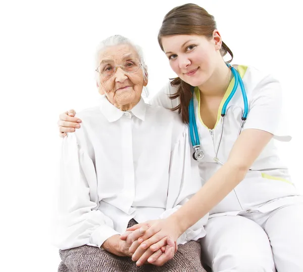 Doctor taking care of an old lady — Stock Photo, Image