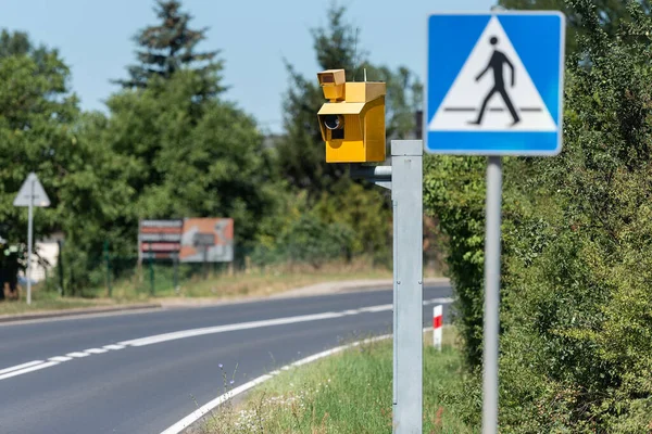 speed camera and pedestrian crossing road sign