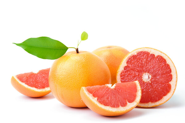 Ripe grapefruit with leaves and slices