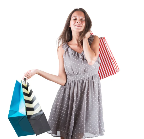 Mujer joven con bolsas aisladas fondo blanco — Foto de Stock