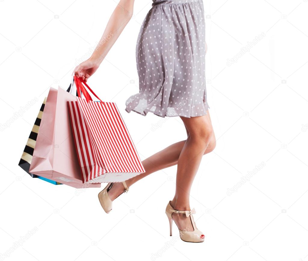 Young woman with shopping bags isolated white background