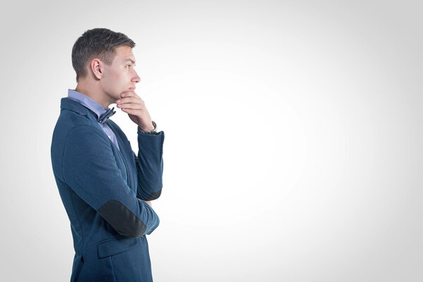 Pensive young handsome man in classical costume doubt think