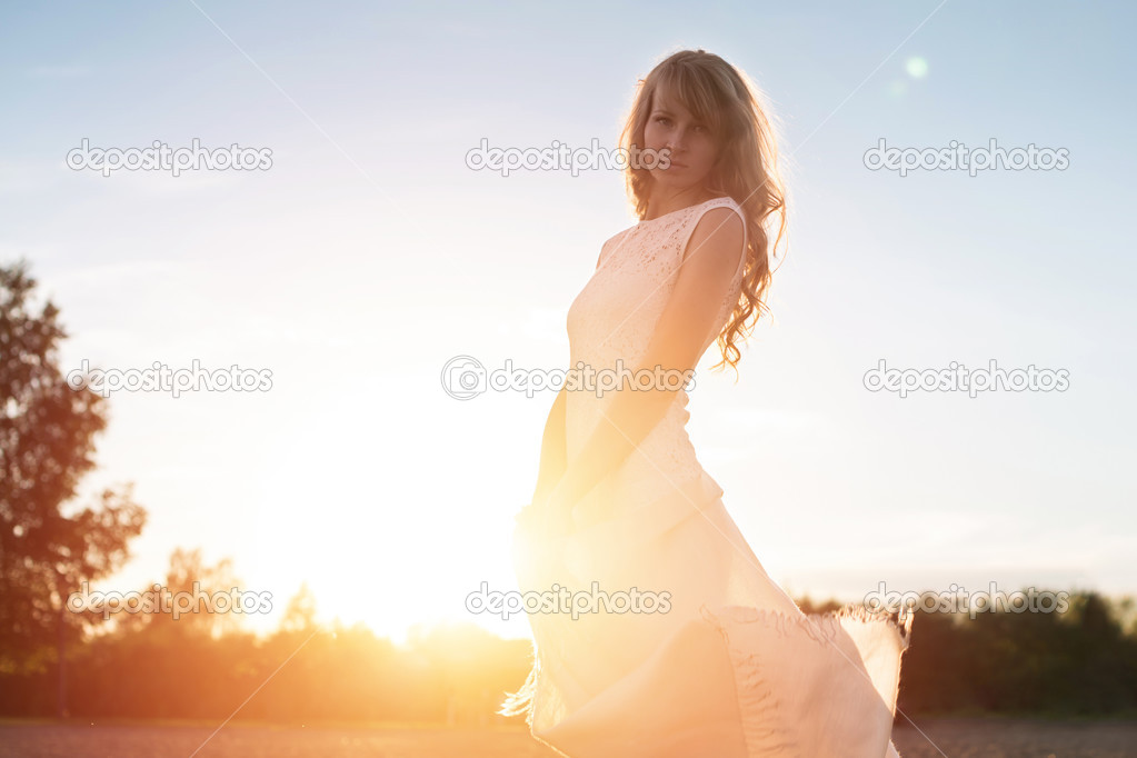 Young woman under sunset light, outdoors portrait. Soft light and Sunshine.