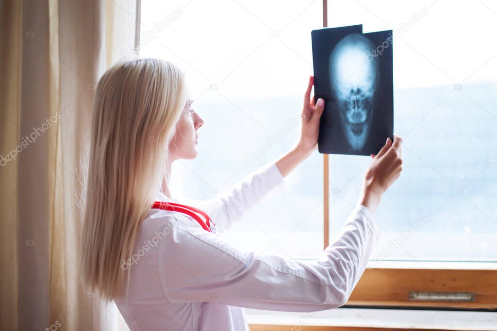 Woman physician. Skull x-ray image of Human head.