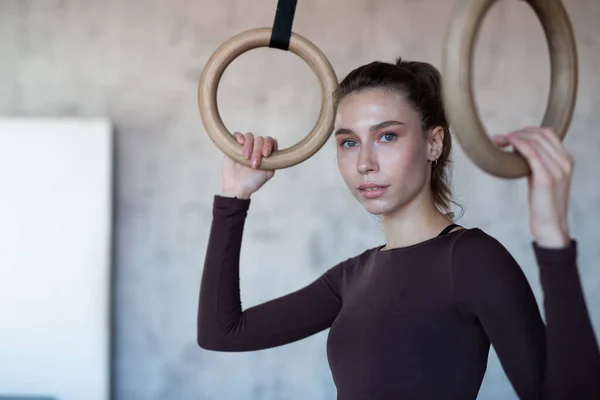 Fit woman with gymnastic rings at the gym — Photo