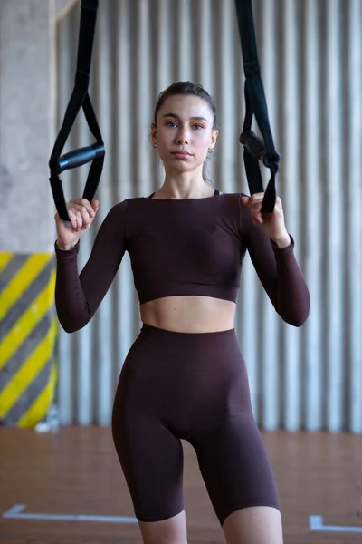 Fit woman standing in the gym with trx — Foto Stock