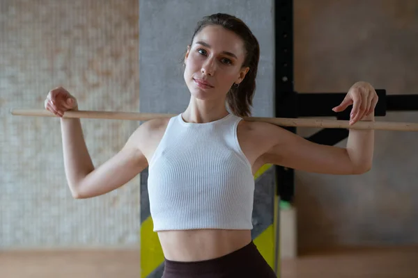 Fit woman with a stick ready to work out — Stock fotografie