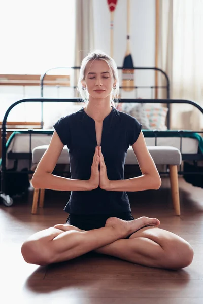 Kobieta ćwicząca jogę w domu. Zdolna kobieta medytująca w pozycji lotosu. — Zdjęcie stockowe
