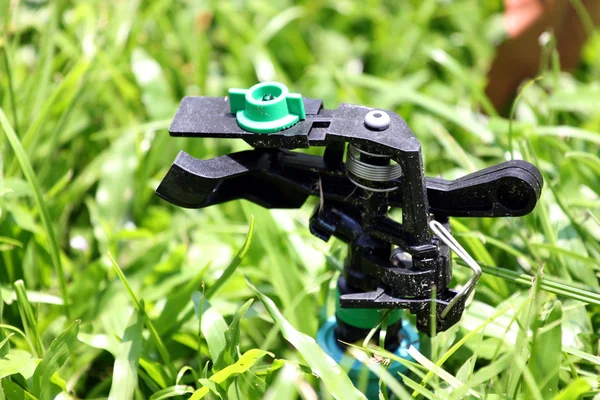 Focus The Sprinkler on Grass. — Stock Photo, Image