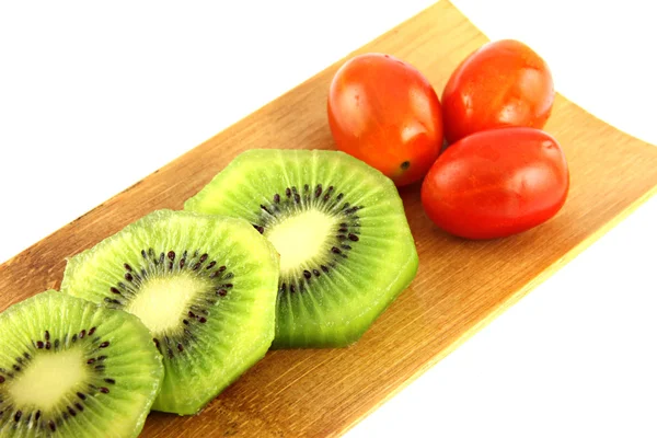 Kiwifruit slices into pieces and three Tomato. — Stock Photo, Image