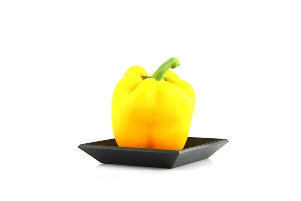Gele paprika in de zwarte bamboe schotel. — Stockfoto