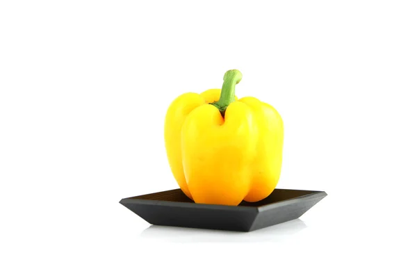 Yellow Sweet pepper in the black Bamboo dish. — Stock Photo, Image