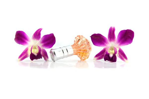 Пурпурная орхидея и оранжевые флакончики духов . — стоковое фото