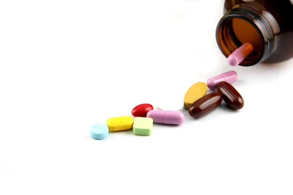 Pill of many color Beside the bottle. — Stock Photo, Image