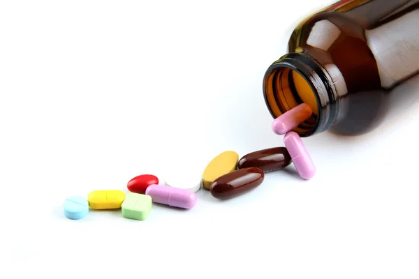 Pill of many color Beside the bottle. — Stock Photo, Image