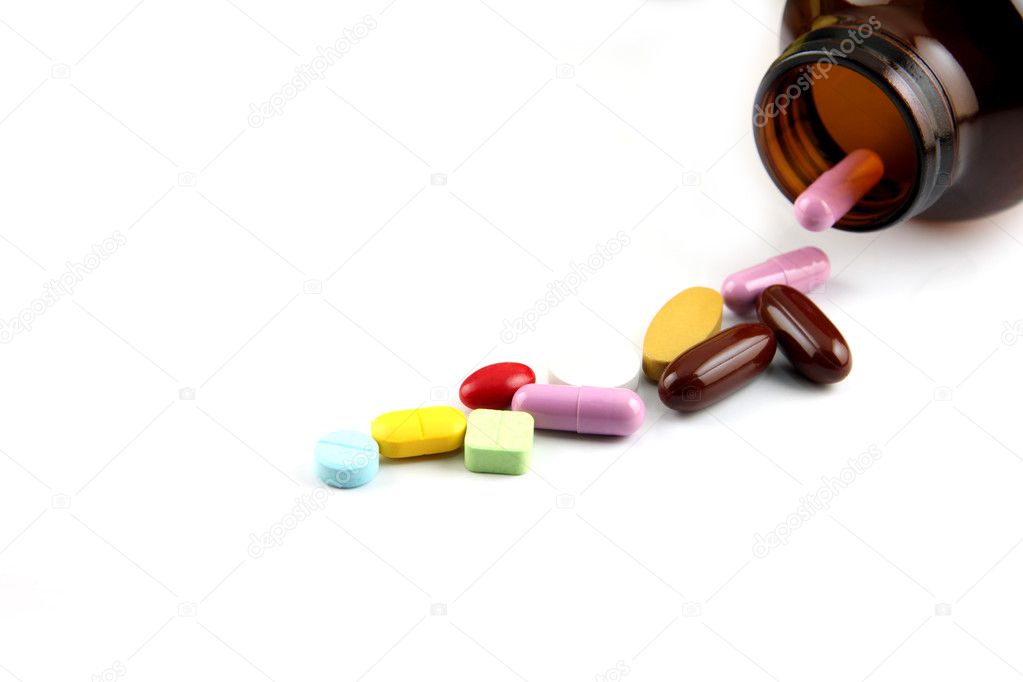 Pill of many color Beside the bottle.