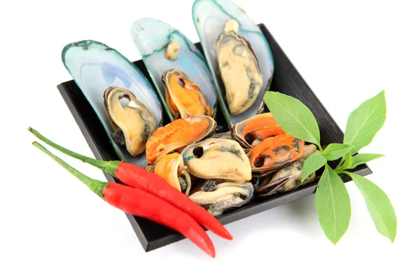 Mussel on black dish and Vegetables placed beside. — Stock Photo, Image