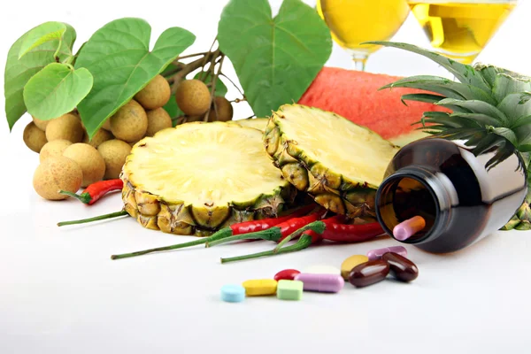 Fruits and medicines placed near the cosmetics. — Stock Photo, Image