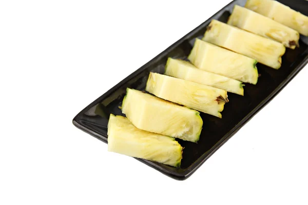 Pineapple slice in the black dish. — Stock Photo, Image