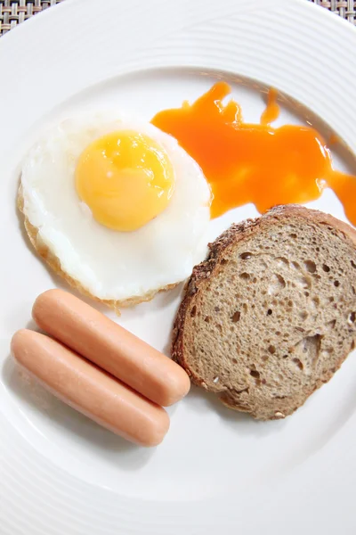 Œufs, pain grillé et saucisse dans un plat blanc . — Photo