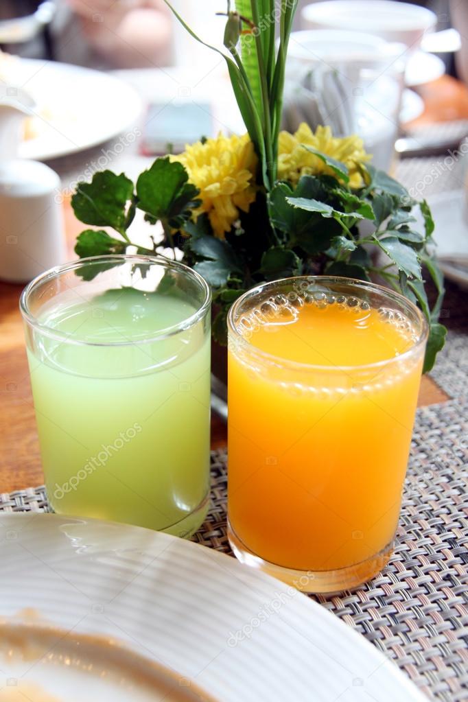 Juice in glass Near the white dish.