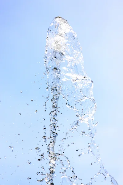 Water spread on a blue background. — Stock Photo, Image