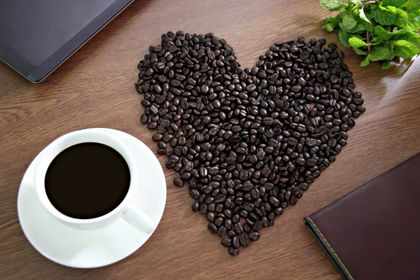 Coffee beans arranged in a heart shape, close to Coffee White an — Stock Photo, Image
