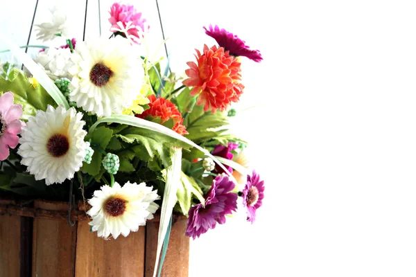 Colorful flowers in a wooden basket. — Stock Photo, Image