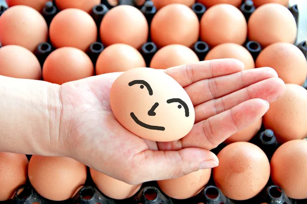 Egg on hands and smile face. — Stock Photo, Image
