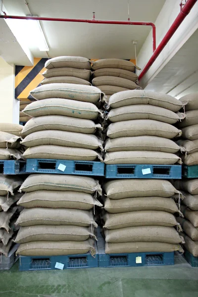 Stacked of Rice sacks in warehouse. — Stock Photo, Image