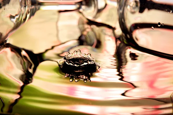 Bunte Wassertropfen und Glas im Schlag. — Stockfoto