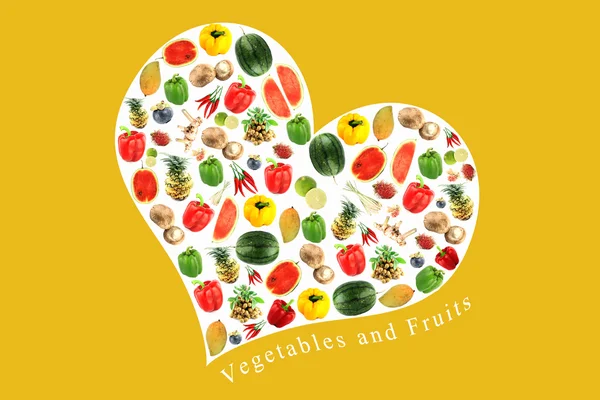 Овочі та фрукти в білому серці на жовтому тлі . — стокове фото