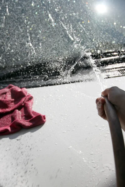 White car washing Front windshield with Water hose. — Stock Photo, Image