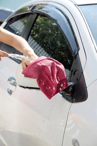 White car washing with fabric and Water hose in house. — Stock Photo, Image