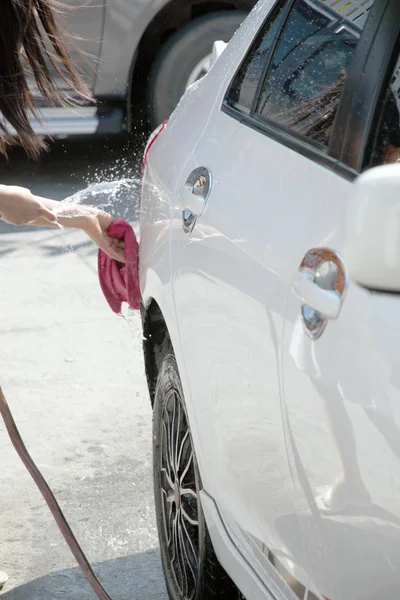 White car washing with Water hose in house. — Stock Photo, Image