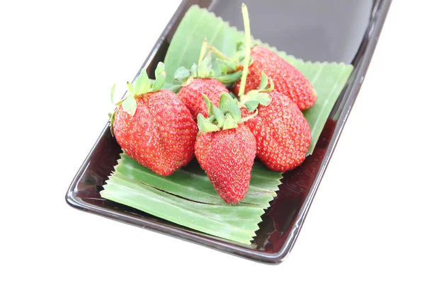 Four Strawberry in black dish. — Stock Photo, Image