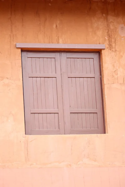 Ancient window of orange wall. — Stock Photo, Image