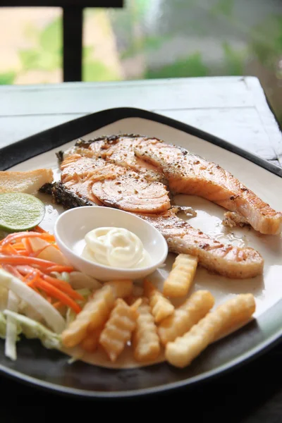Grilled salmon steak with french fries and toast. — Stock Photo, Image