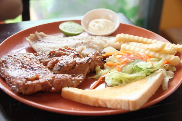 Grilled pork steak with french fries and toast. — Stock Photo, Image