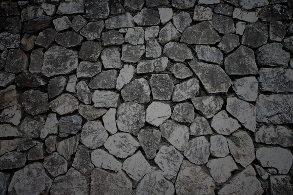 Color oscuro de textura de pared de piedra . — Foto de Stock