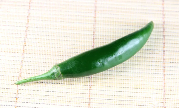 Green fresh paprika on bamboo background. — Stock Photo, Image