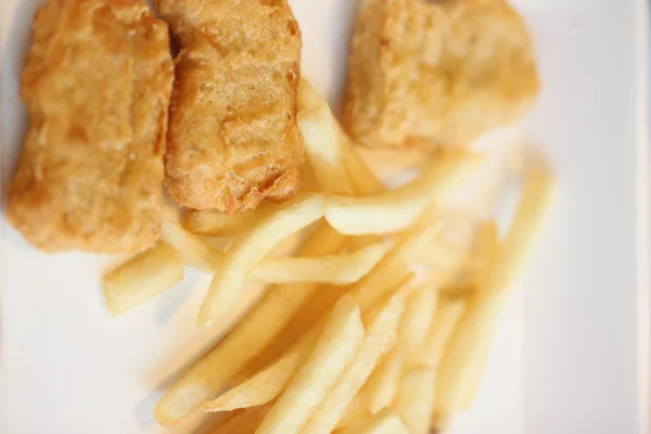 French fries and fried chicken on dish. — Stock Photo, Image