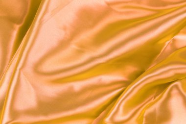 Gold wrinkled cloth background for design in your work concept.