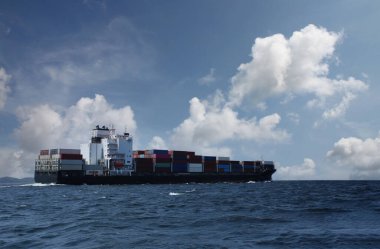 Cargo ship on the sea in a clear day and clear sky,Minimal of sea transportation.