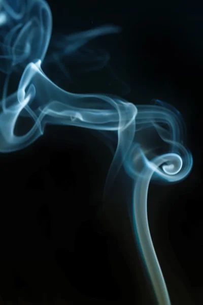 Swirling smoke from the incense on a homogeneous background — Stock Photo, Image