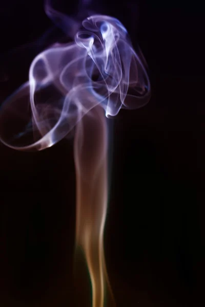 Swirling smoke from the incense on a homogeneous background — Stock Photo, Image