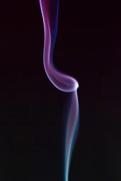 Swirling smoke from the incense on a homogeneous background — Stock Photo, Image
