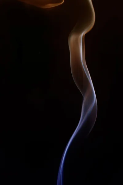 Swirling smoke from the incense on a homogeneous background — Stock Photo, Image