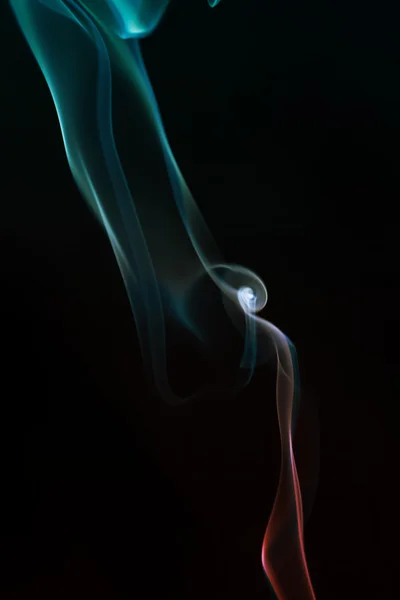 Swirling smoke from the incense on a homogeneous background — Stock Photo, Image